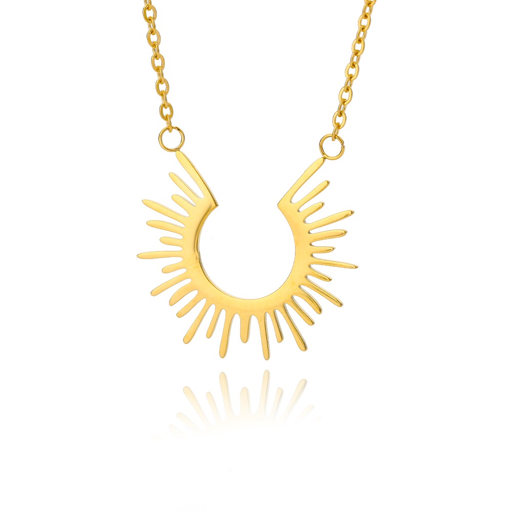 Un collier doré en forme de soleil en demi-cercle sur fond blanc.